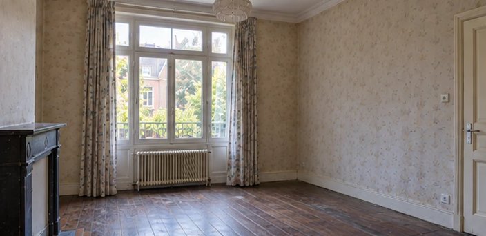 Séjour avant rénovation : papier peint défraîchi, parquet sombre abîmé